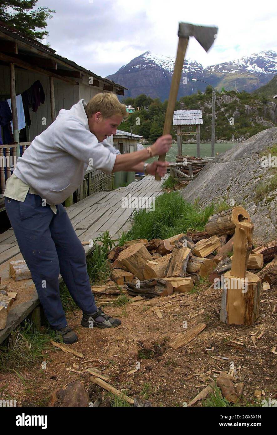 Prince William chops logs outside the team's accommodation in the village of Tortel, Southern Chile during his Raleigh International expedition. December 11th 2000.  Photo.  Anwar Hussein  Stock Photo