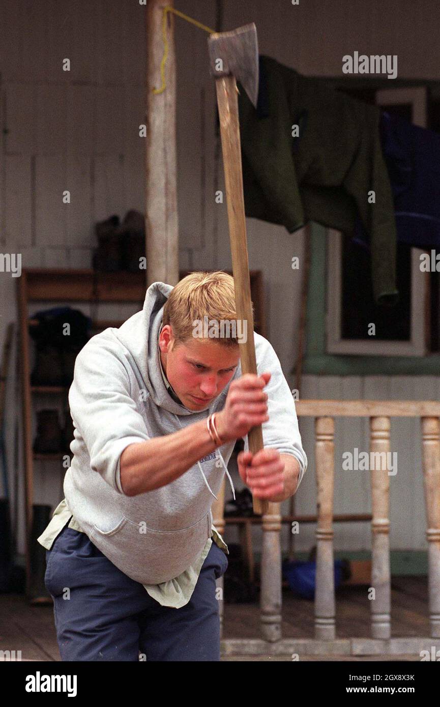 Prince William chops logs outside the team's accommodation in the village of Tortel, Southern Chile during his Raleigh International expedition in December 2000.  Photo.  Anwar Hussein  Stock Photo