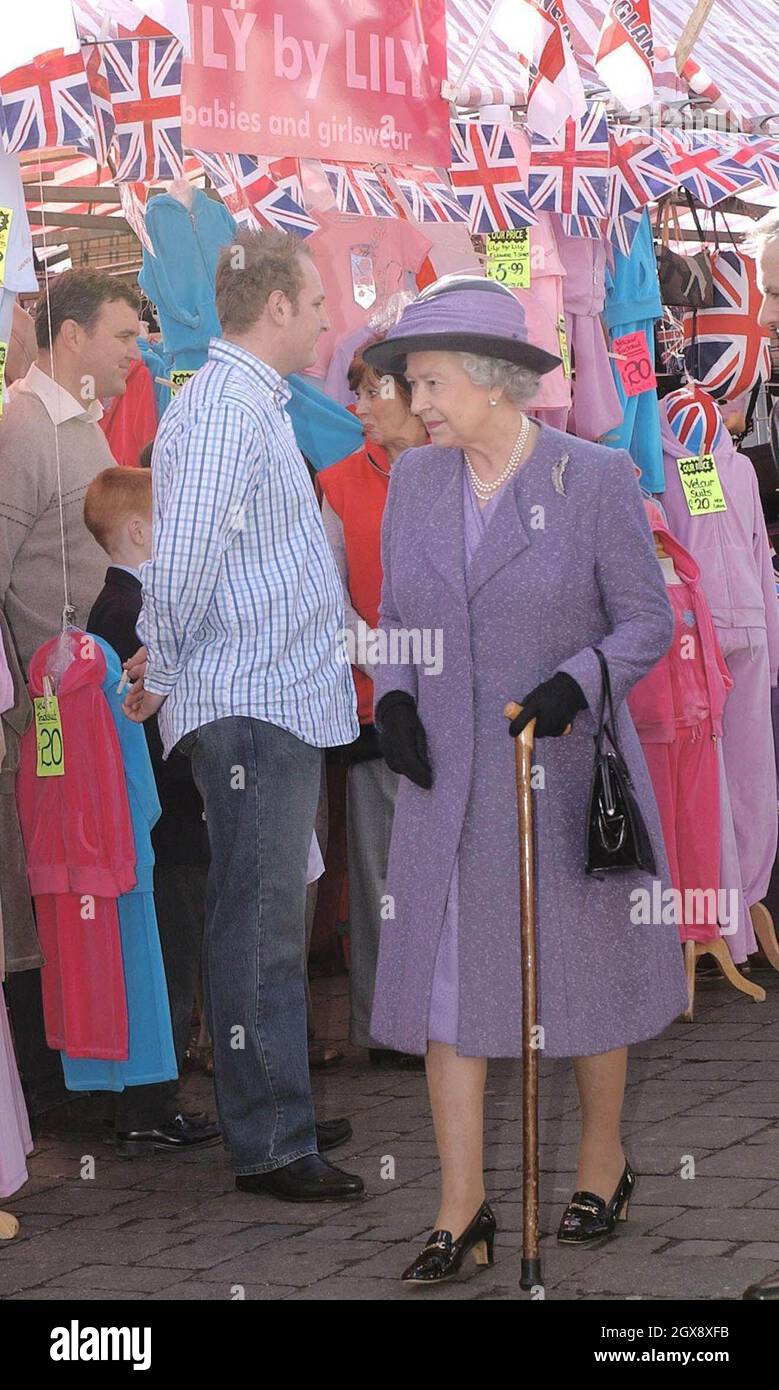 The Queen meets well wishers during a walkabout in the market square, Romford, Thursday March 6, 2003. The Queen, who has travelled the globe visiting some of the world's most famous destinations, has never before visited the area, famous for Cockney rhyming slang and its East End connections.  Full length, royals, hat, union jack, walking stick.  Â©Anwar Hussein/allaction.co.uk  Stock Photo