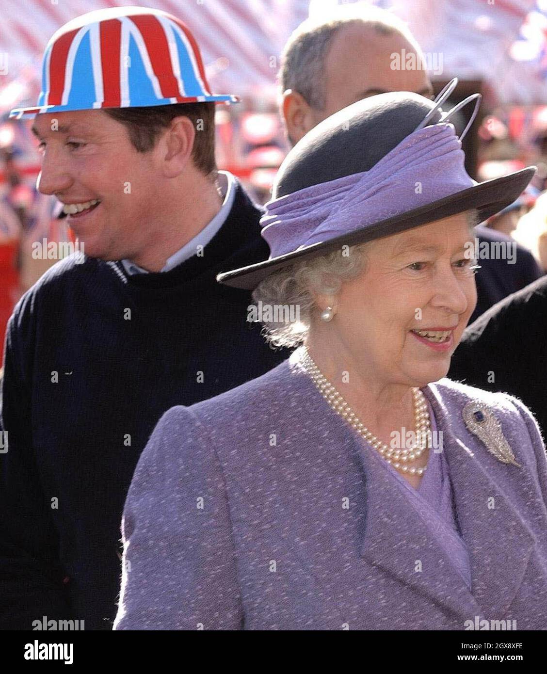 The Queen meets well wishers during a walkabout in the market square, Romford, Thursday March 6, 2003. The Queen, who has travelled the globe visiting some of the world's most famous destinations, has never before visited the area, famous for Cockney rhyming slang and its East End connections.  Head shot, royals, hat, union jack.  Â©Anwar Hussein/allaction.co.uk  Stock Photo