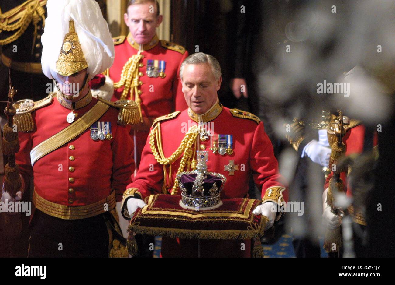 The state crown is carried into the chamber for the State Opening of ...