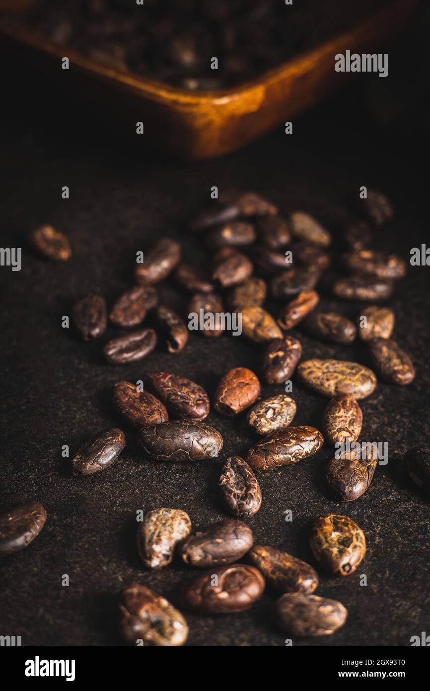 Roasted cocoa beans on black table. Stock Photo