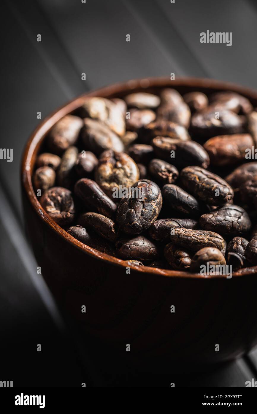 Roasted cocoa beans on black table. Stock Photo