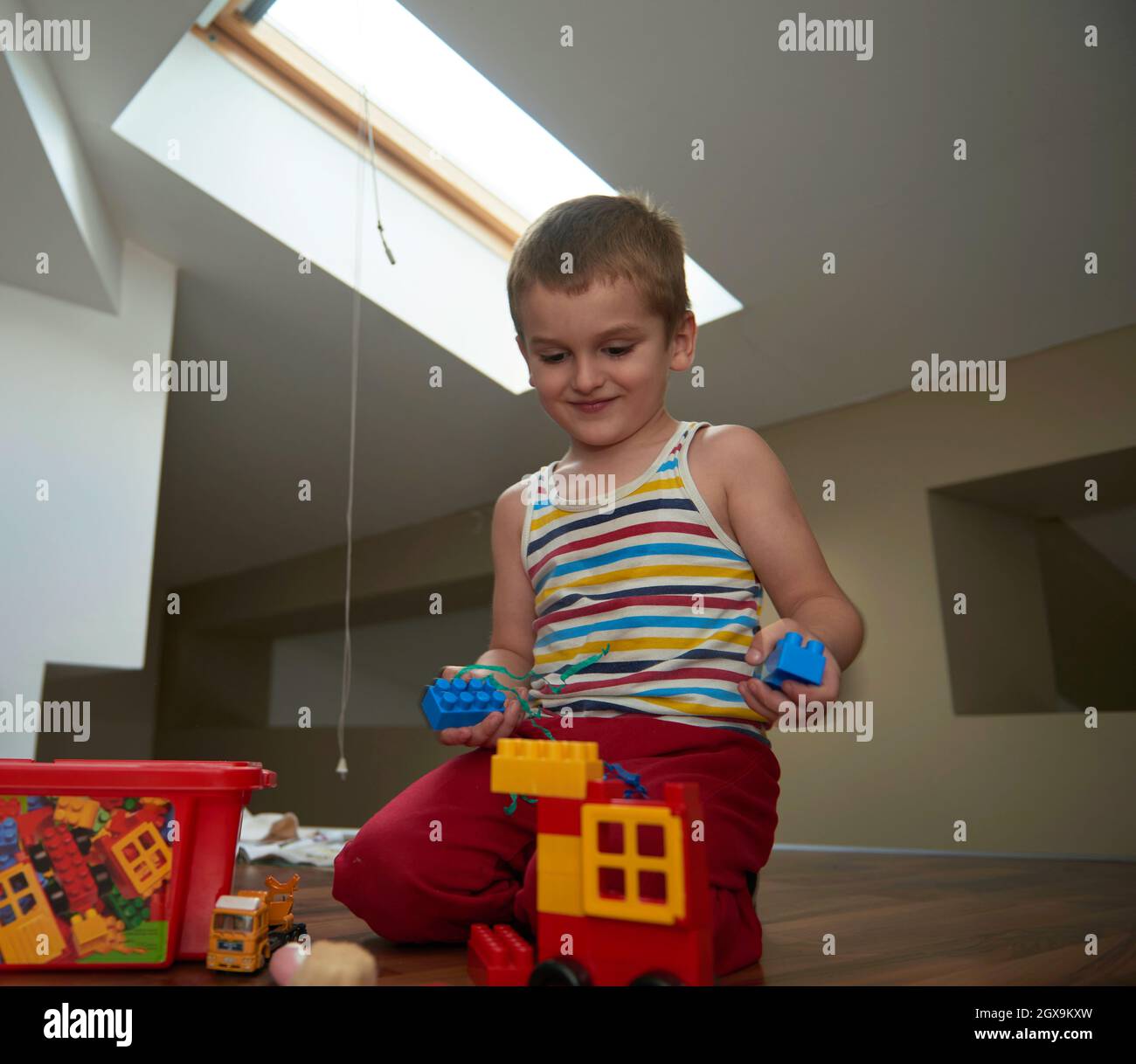 Little boy child playing with creative plastic toys indoor, building ...