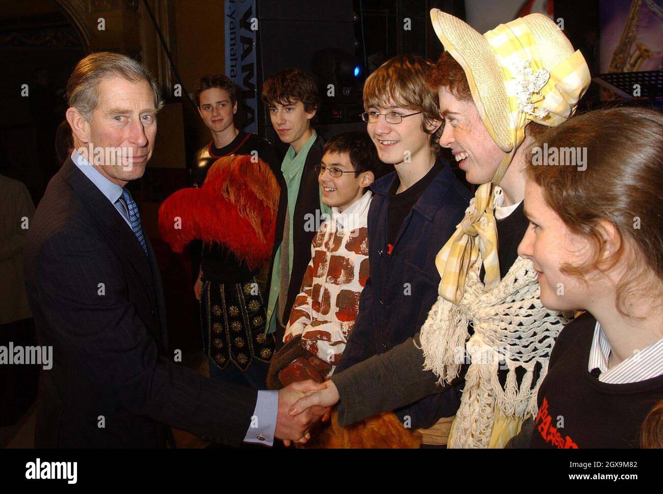 The Prince of Wales shakes hands with members of the St Aidan's High School Drama club, who performed extracts from William Shakespeare's 'A Midsummer Night's Dream', at the Hackney Empire, east London. The Prince visited the theatre which is currently being restored as he launched the Arts & Kids Foundation's One Million kids Challenge, which aims to get youngsters involved in the arts by the year 2008.   Â©Anwar Hussein/allactiondigital.com    NO UK USE FOR 28 DAYS - READY FOR USE ON 2ND JANUARY 2004  Stock Photo