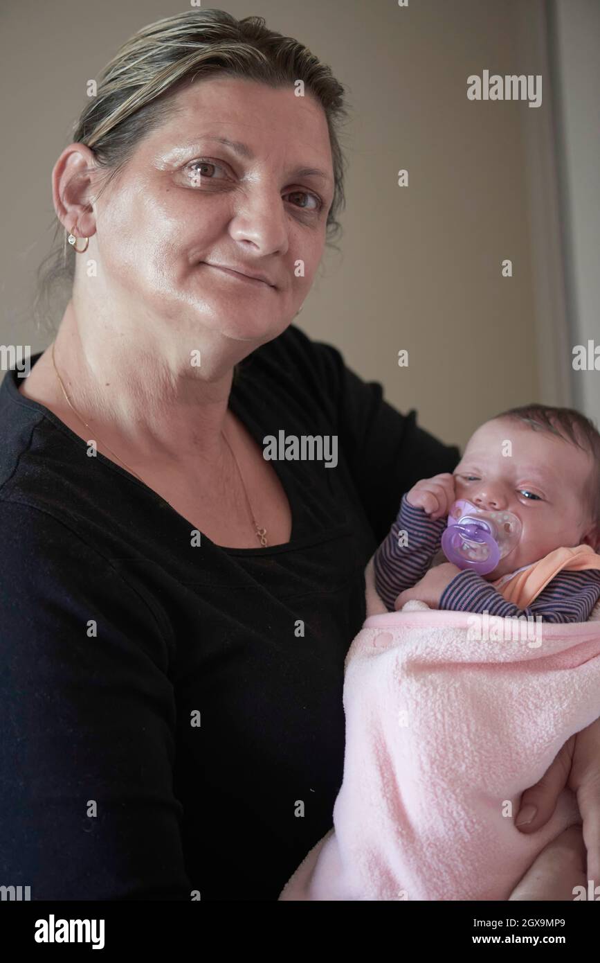 happy grandmother holding newborn baby at home Stock Photo Alamy