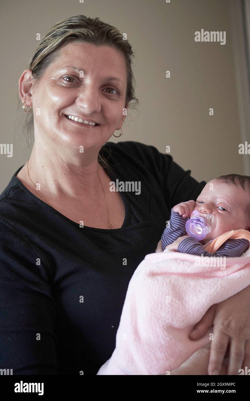 happy grandmother holding newborn baby at home Stock Photo Alamy