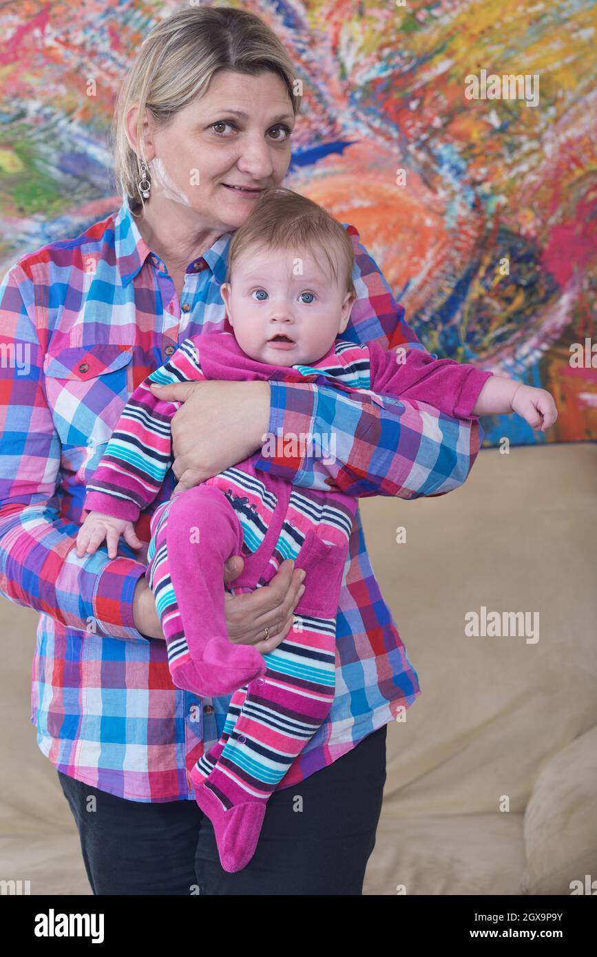 happy grandmother holding newborn baby at home Stock Photo Alamy
