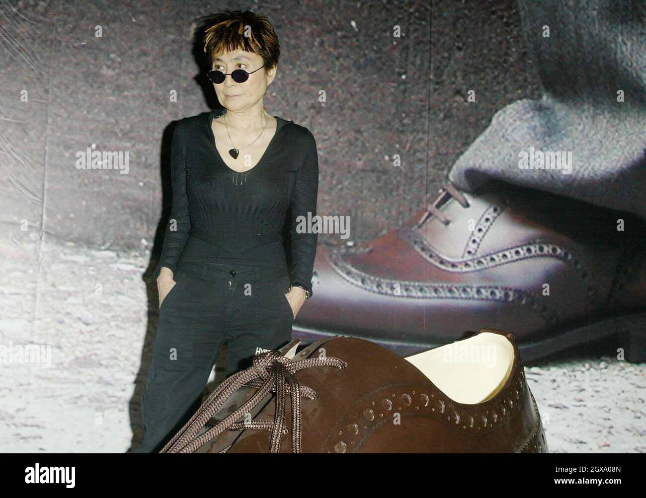 Yoko Ono at the opening of her art installation 'Odyssey of a Cockroach'.  The conceptual artist posed next to the objects that a cockroach would come  across during a stroll around New