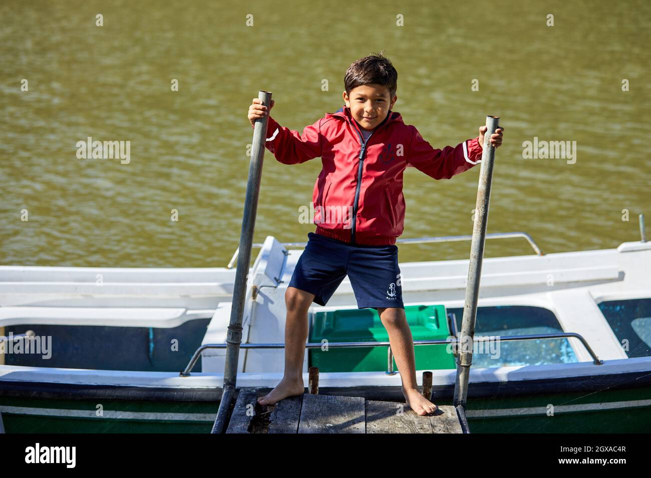 Child 5-10 years on the jetty, Zumaia, Gipuzkoa, Basque Country, Spain Stock Photo