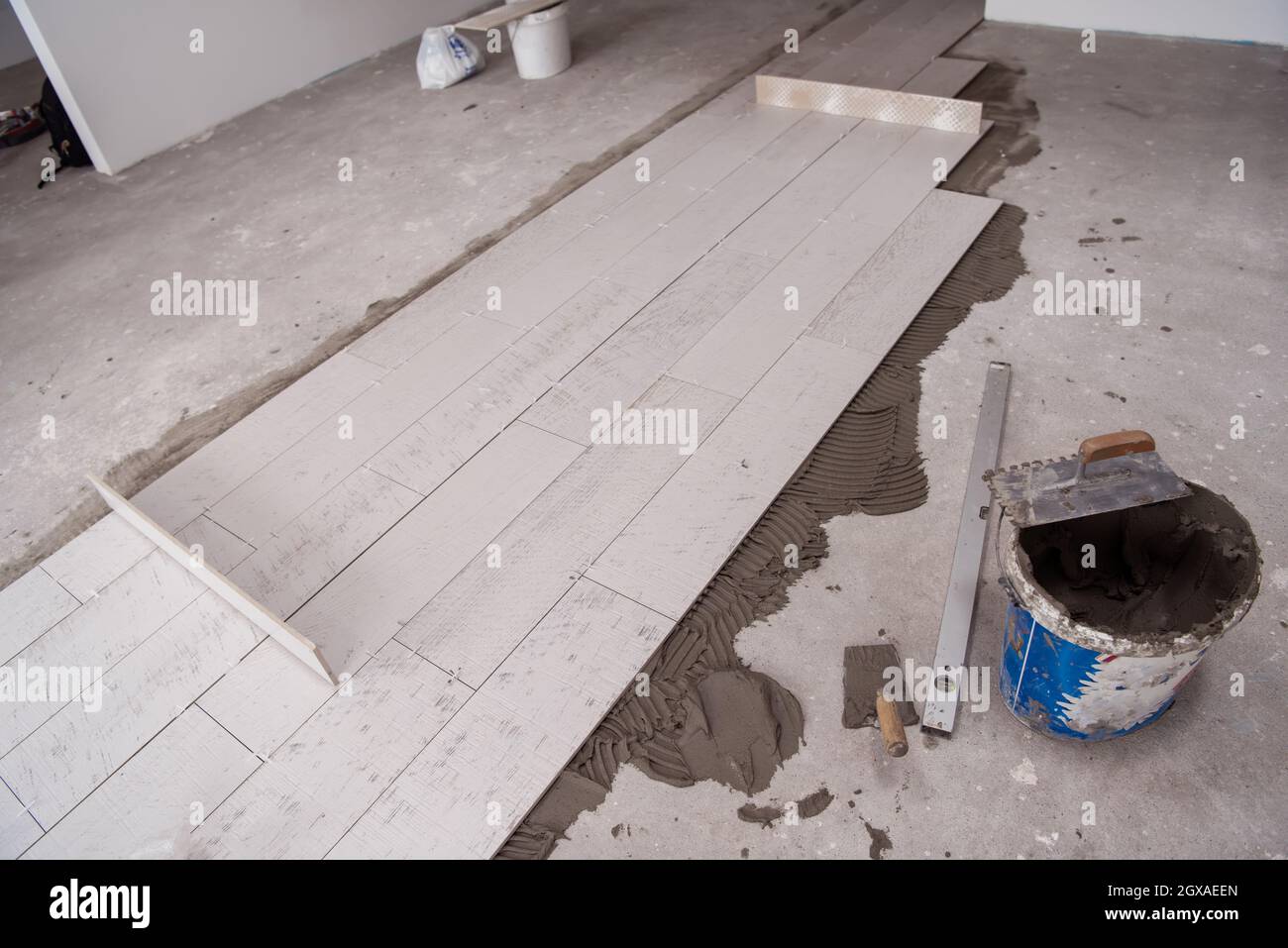 Ceramic wood effect tiles and tools for tiler on the floor unfinished