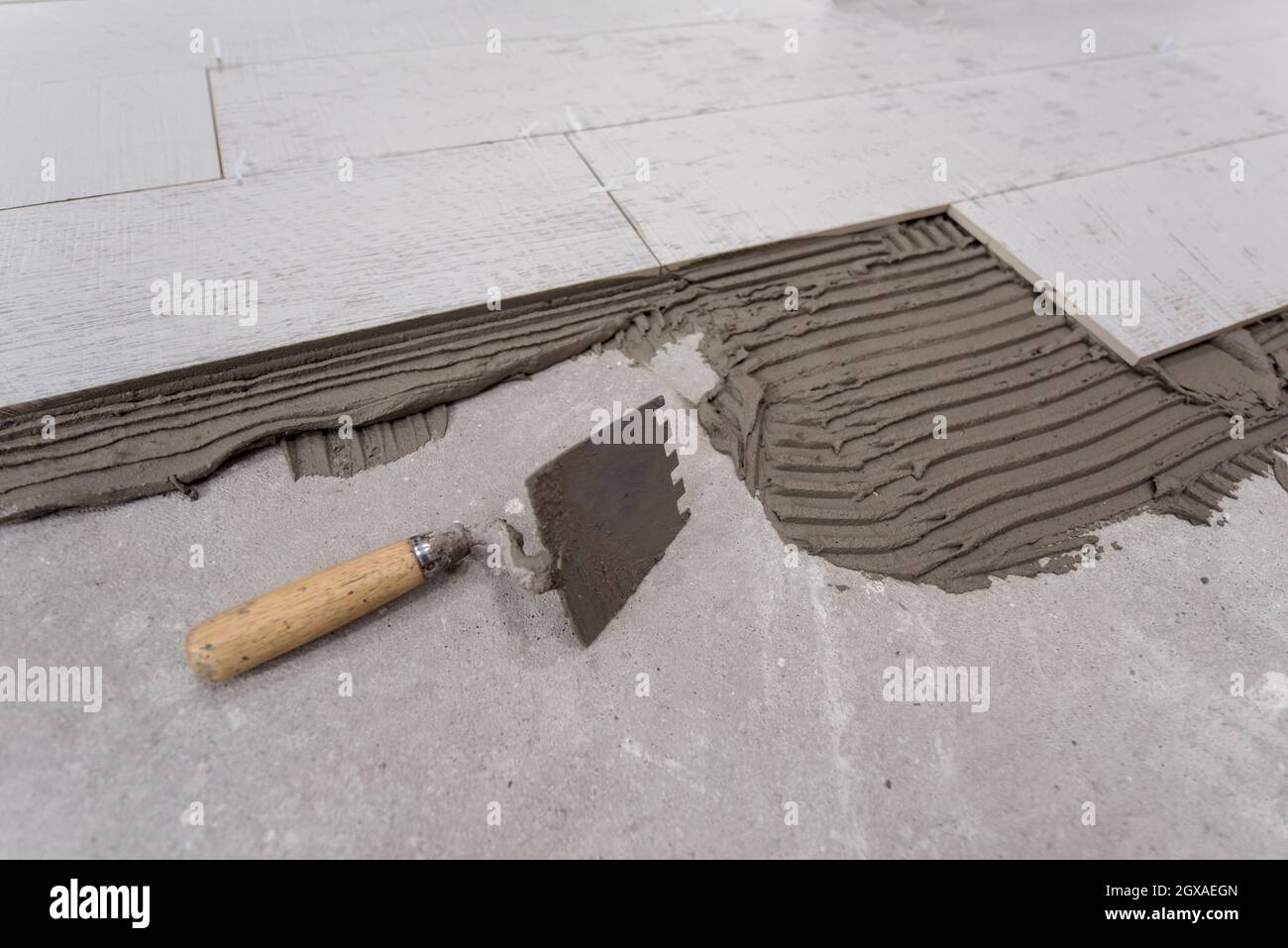 Ceramic wood effect tiles and tools for tiler on the floor unfinished