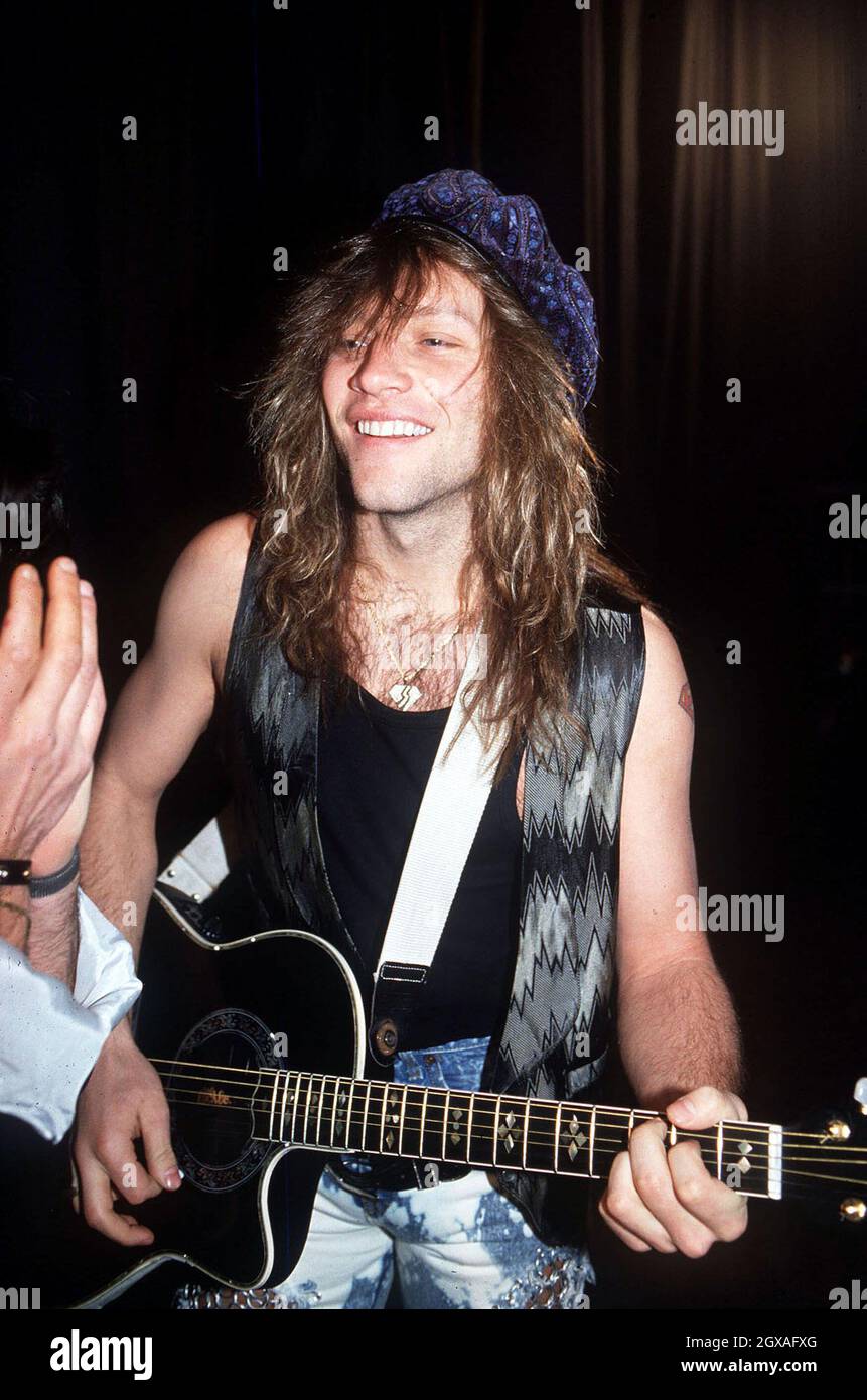 Jon Bonjovi playing an acoustic guitar. Mid-1980's arcive picture Stock  Photo - Alamy, image size:861x1390