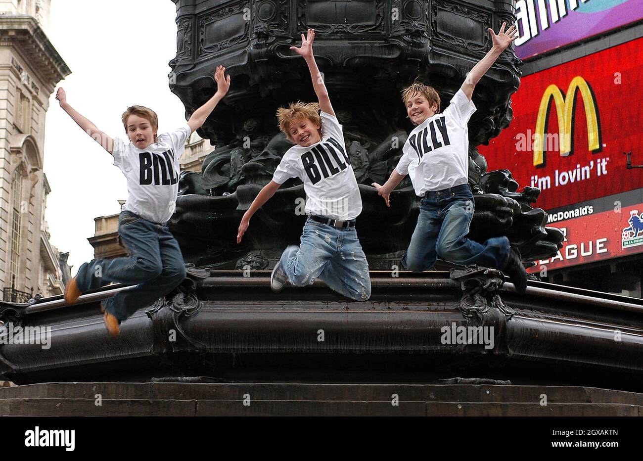 Stephen Daldry, director, introduces the three young actors, picked from over 3000 hopefuls to play title role in the musical of Billy Elliott.  The boys from the left are Liam Mower, 12 years old, George Maguire, 13 years old and James Lomas, 14 years old.   Stock Photo