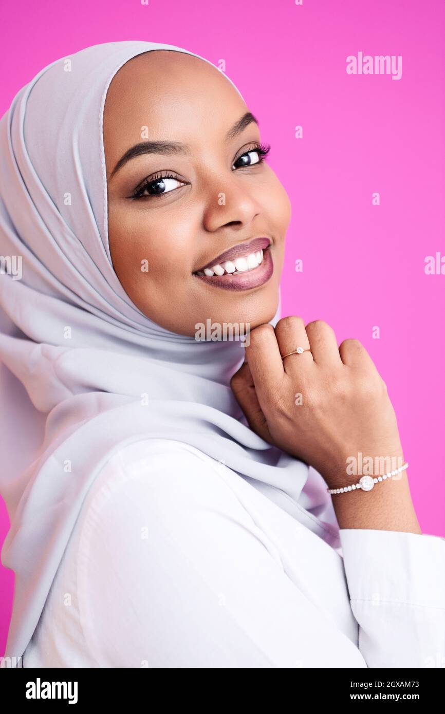 Premium Photo  Portrait of young modern muslim beauty wearing traditional islamic  clothes on plastic pink background. selective focus. high-quality photo