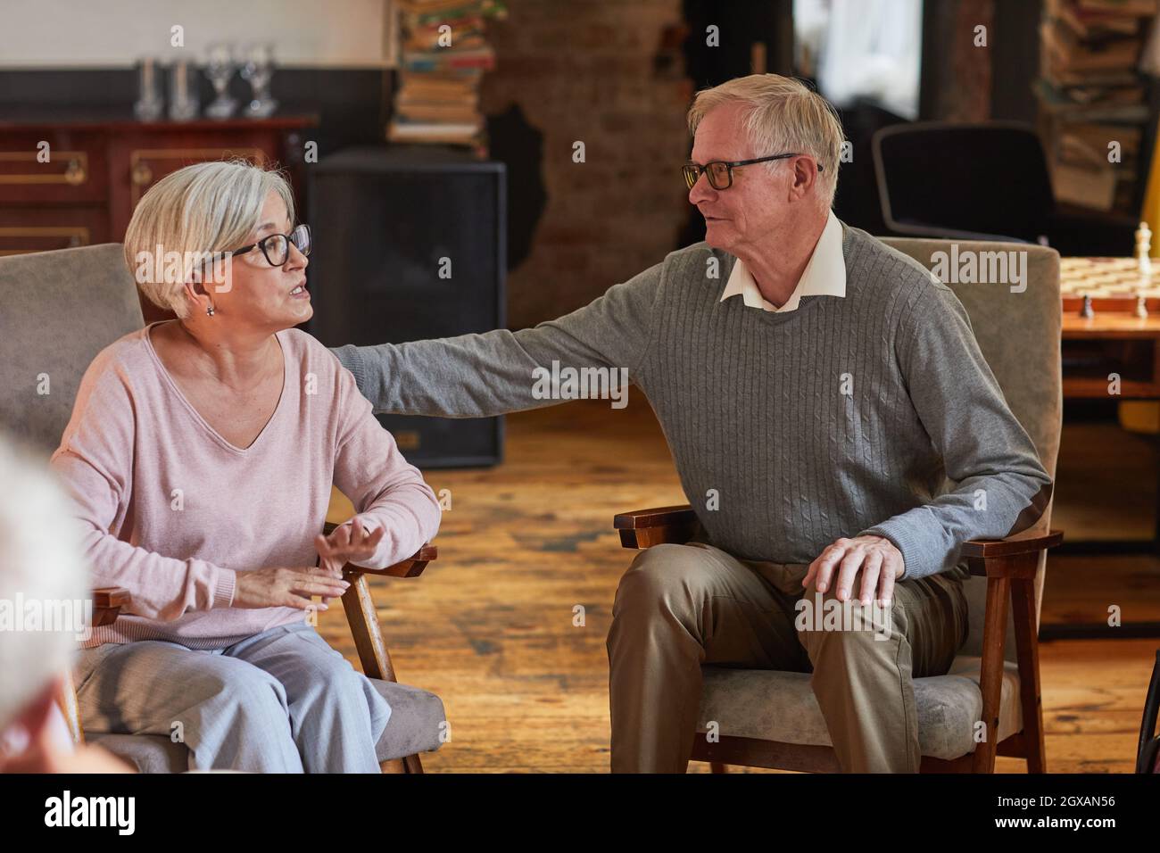 Portrait of senior people supporting each other during therapy session at retirement home, copy space Stock Photo