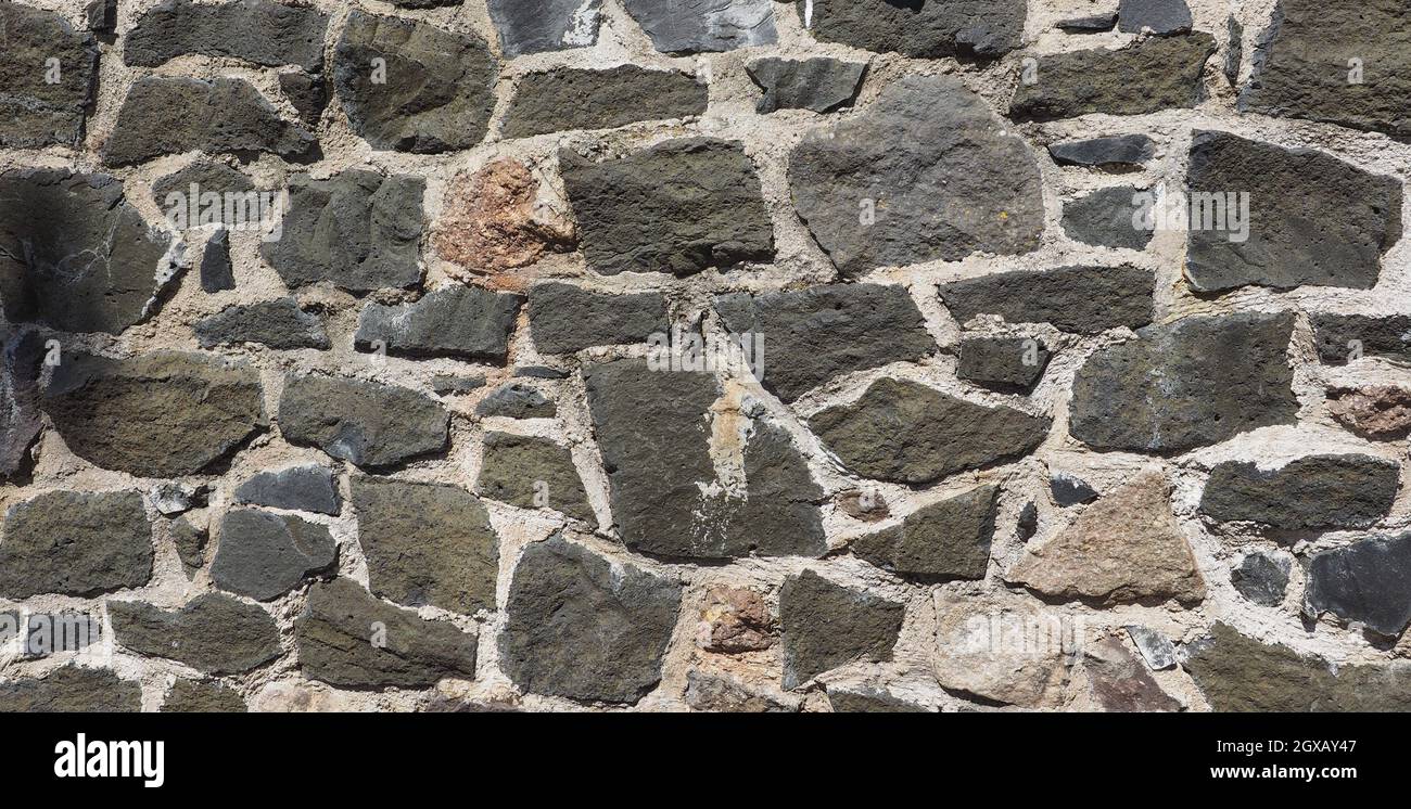 grey stone wall useful as a background Stock Photo - Alamy