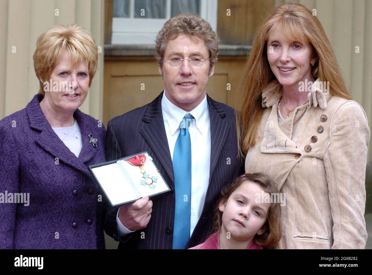 Roger Daltrey from the The Who poses with his wife Heather (right), sister Jill Dale (left) and grand-daughter Lily, 6,  in the courtyard of Buckingham Palace in central London, Wednesday February 9, 2005. The singer had just been honoured as a Commander of the British Empire (CBE) for services to music. Anwar Hussein/allactiondigital.com   Stock Photo