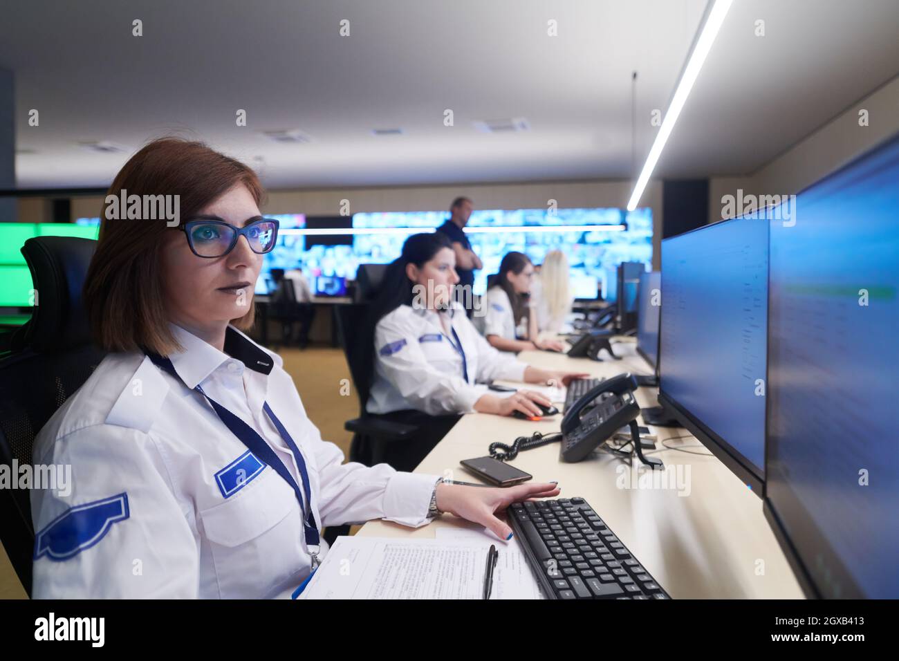 Group of Security data center operators working in a CCTV monitoring ...
