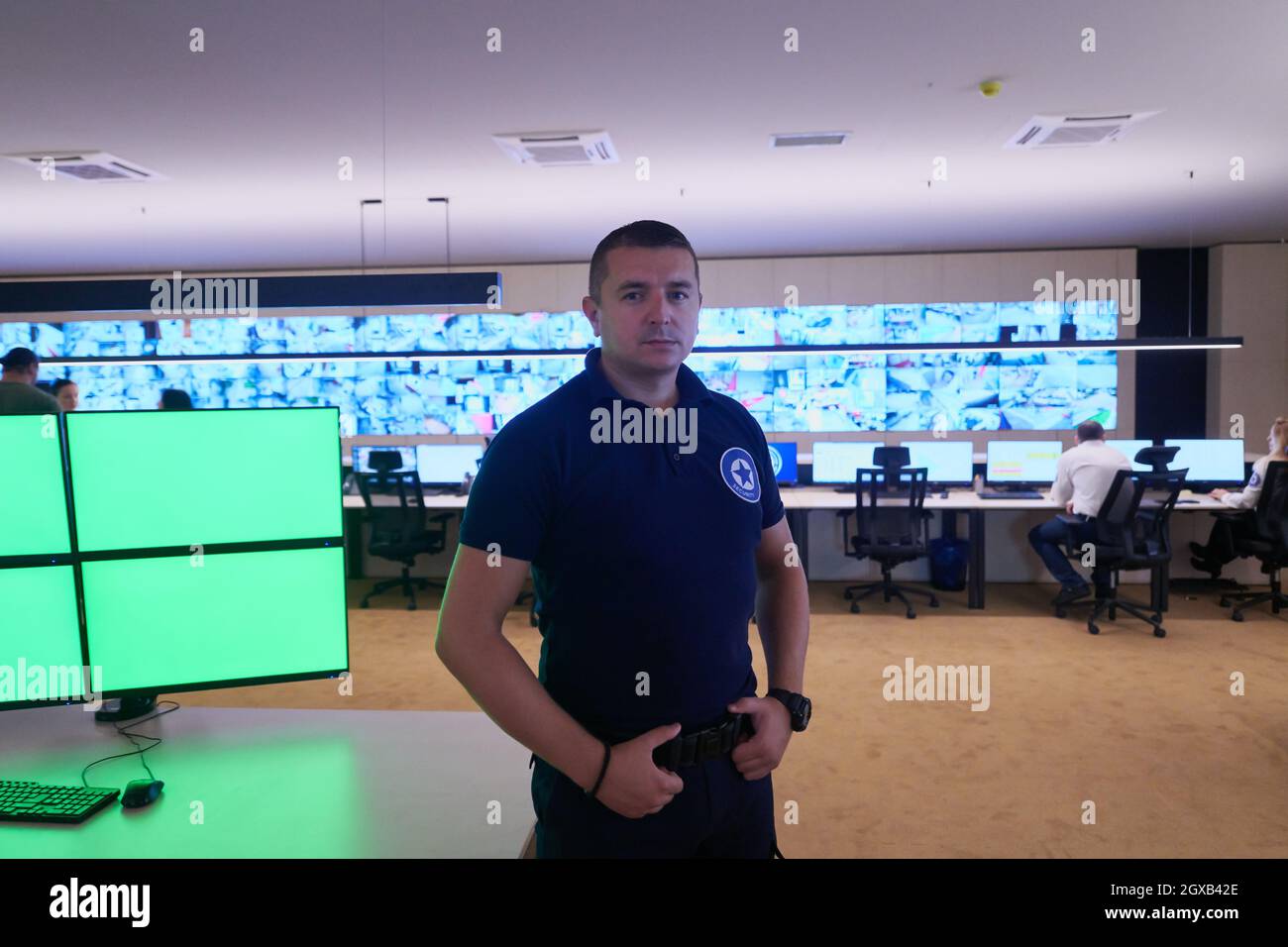 portrait of young male security operator working in a data system ...