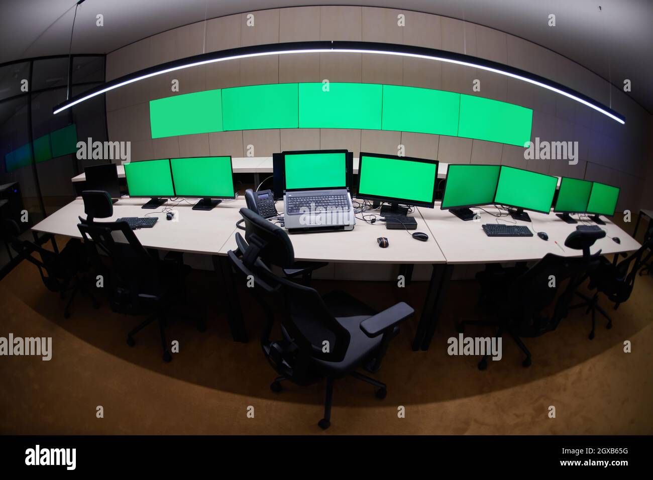 Empty interior of big modern security system control room with blank