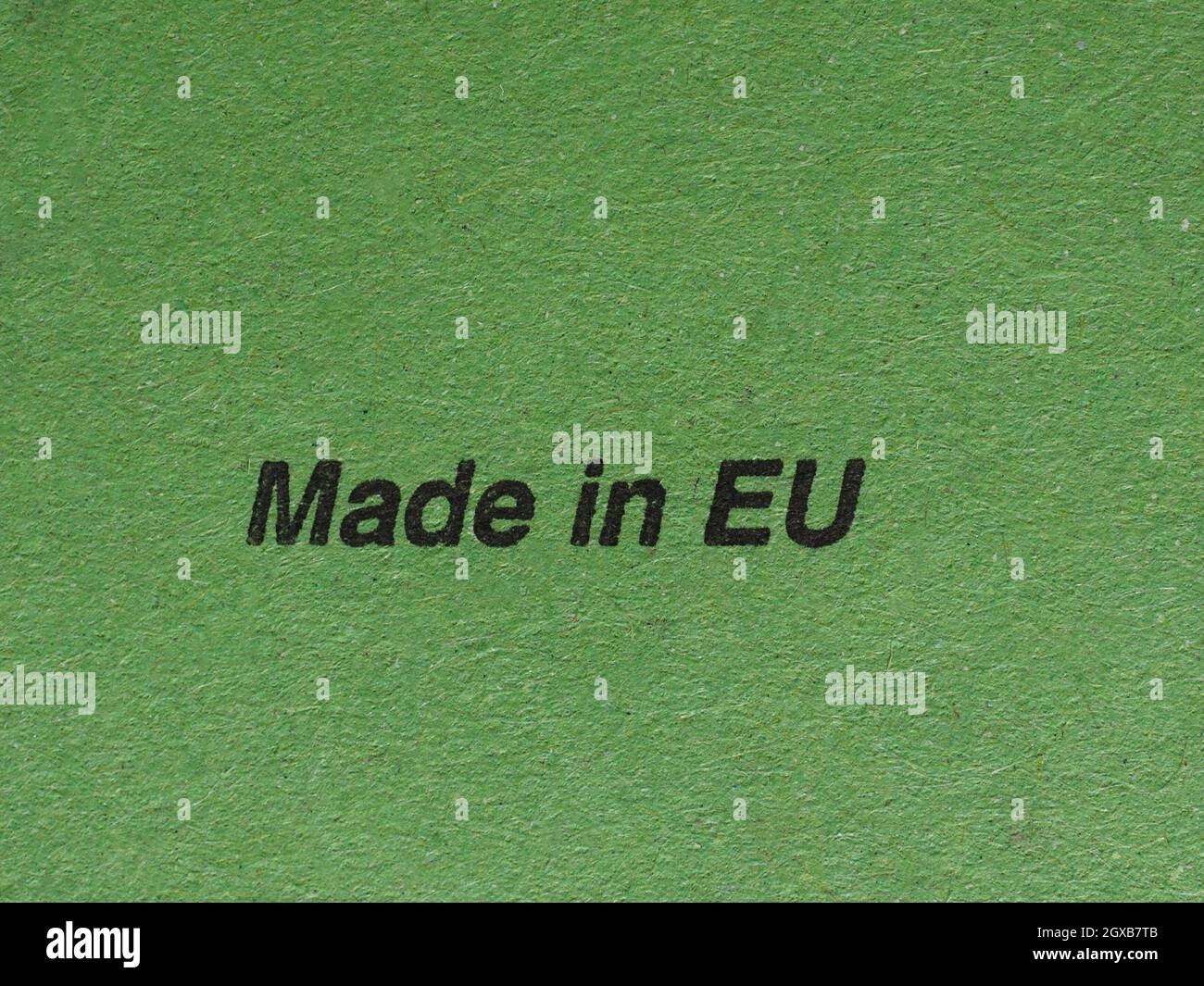 Made in EU (meaning European Union) written on green paper. Stock Photo