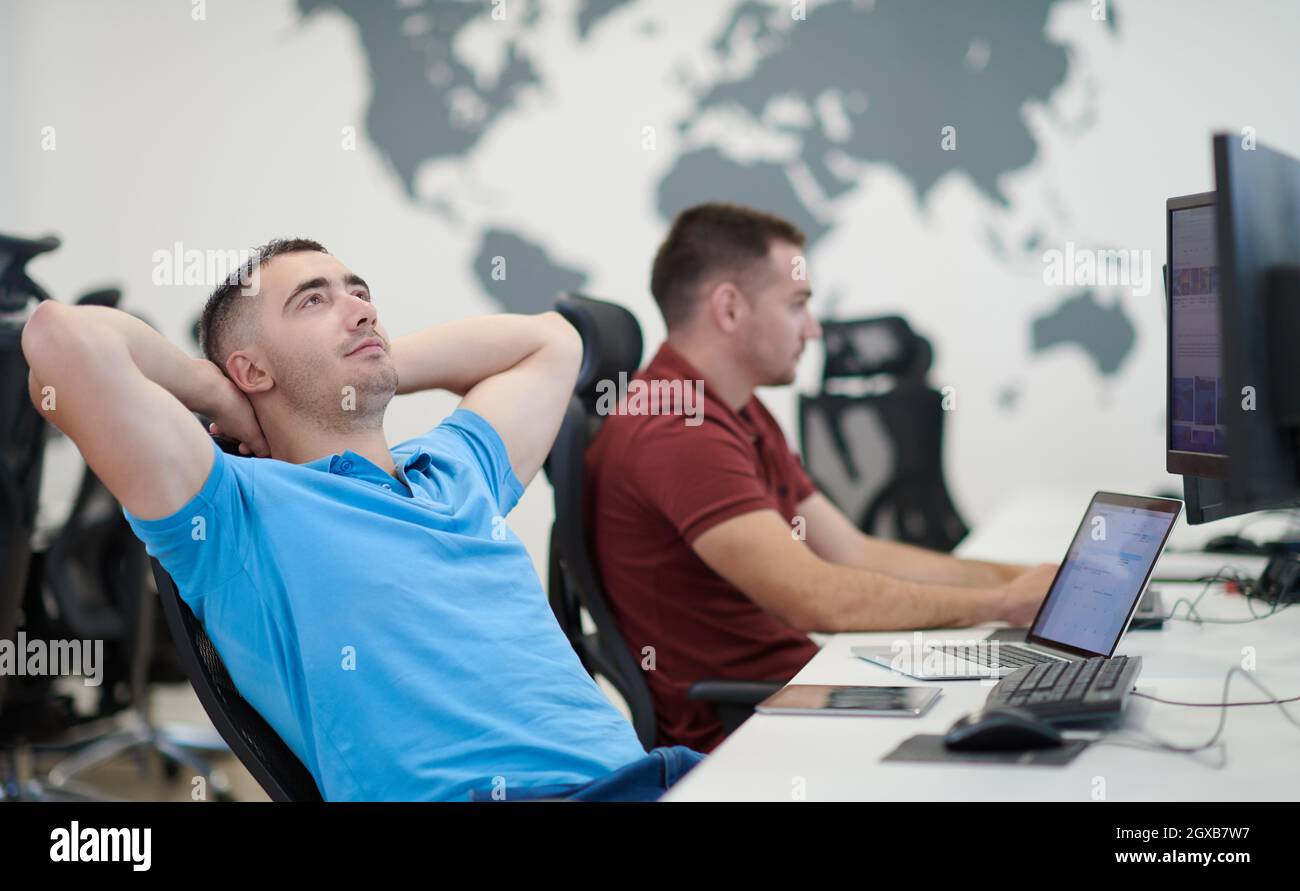 startup business, two male software developers working on computer at new modern open plan office Stock Photo