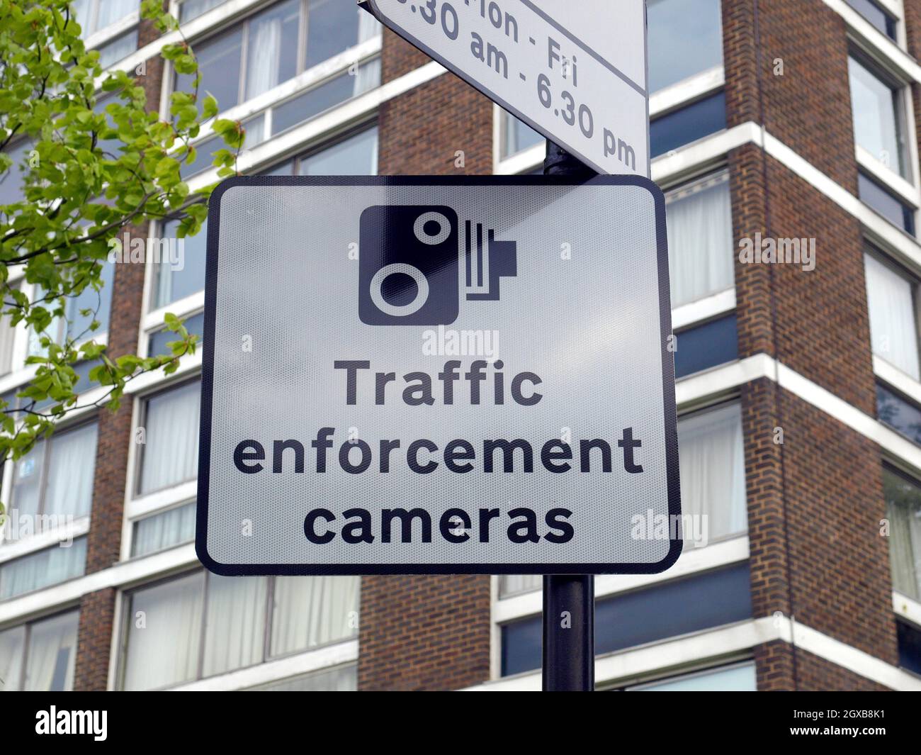 Traffic enforcement cameras sign with urban building background. Stock Photo