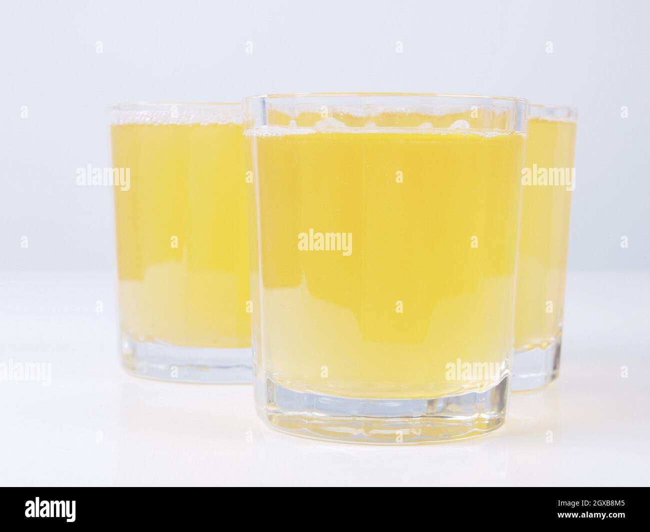 Glasses of pineapple juice on continental breakfast table. Stock Photo