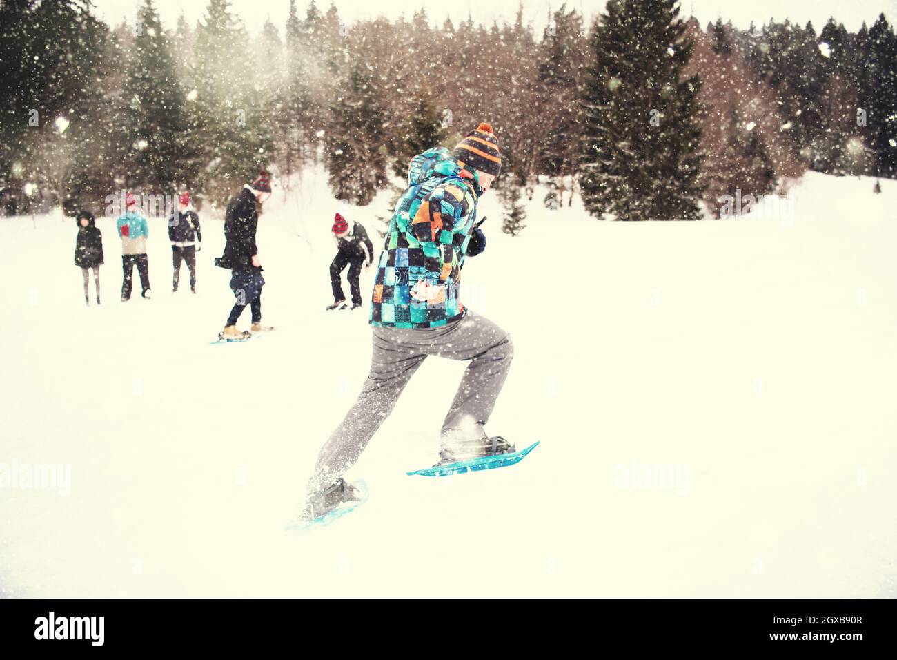 group of young happy business people having a running competition using snowshoes while enjoying