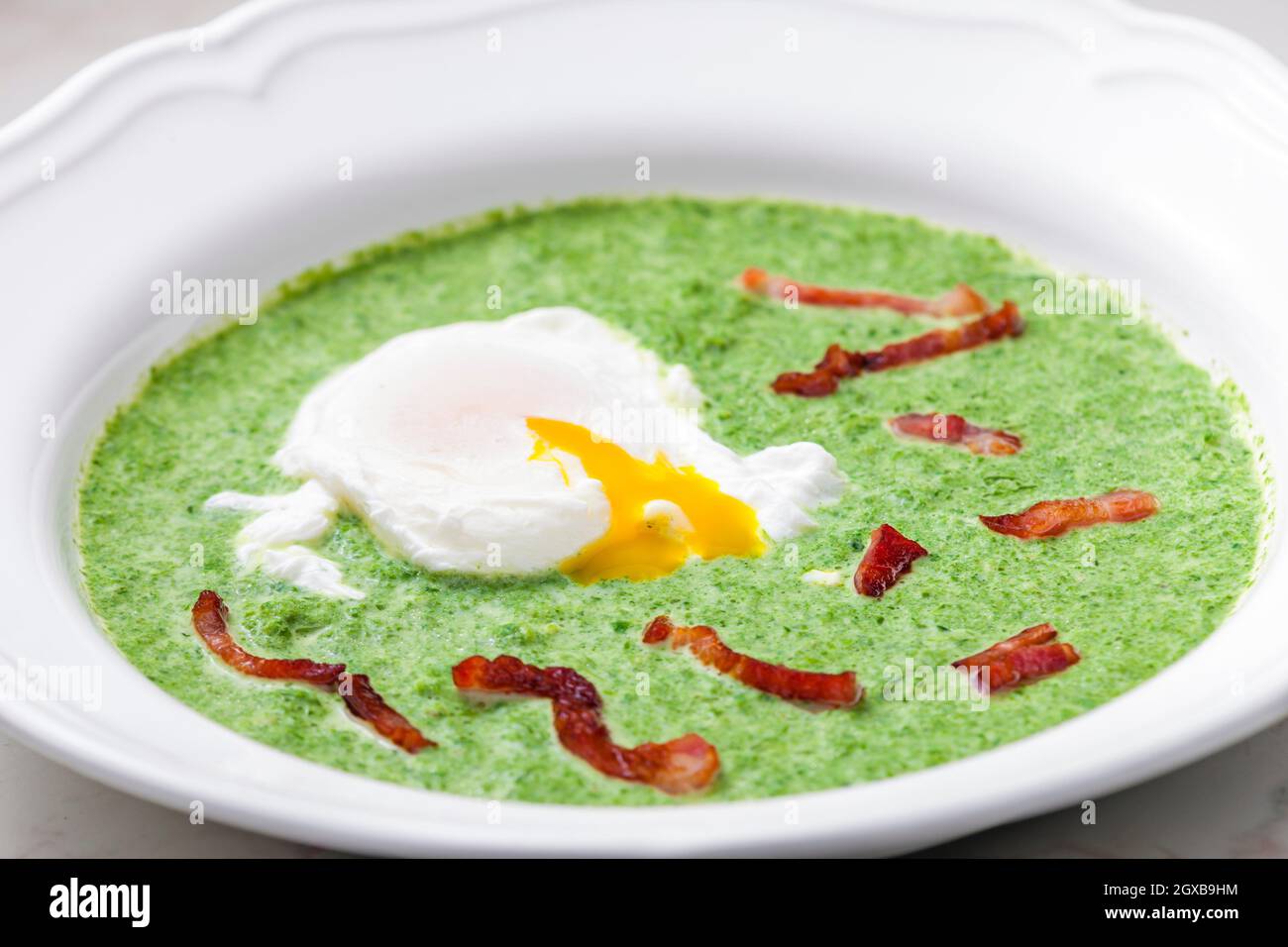 creamy spinach soup with poached egg and bacon Stock Photo Alamy