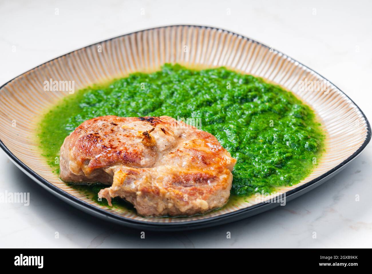 still life of pork cutlet with spinach Stock Photo Alamy