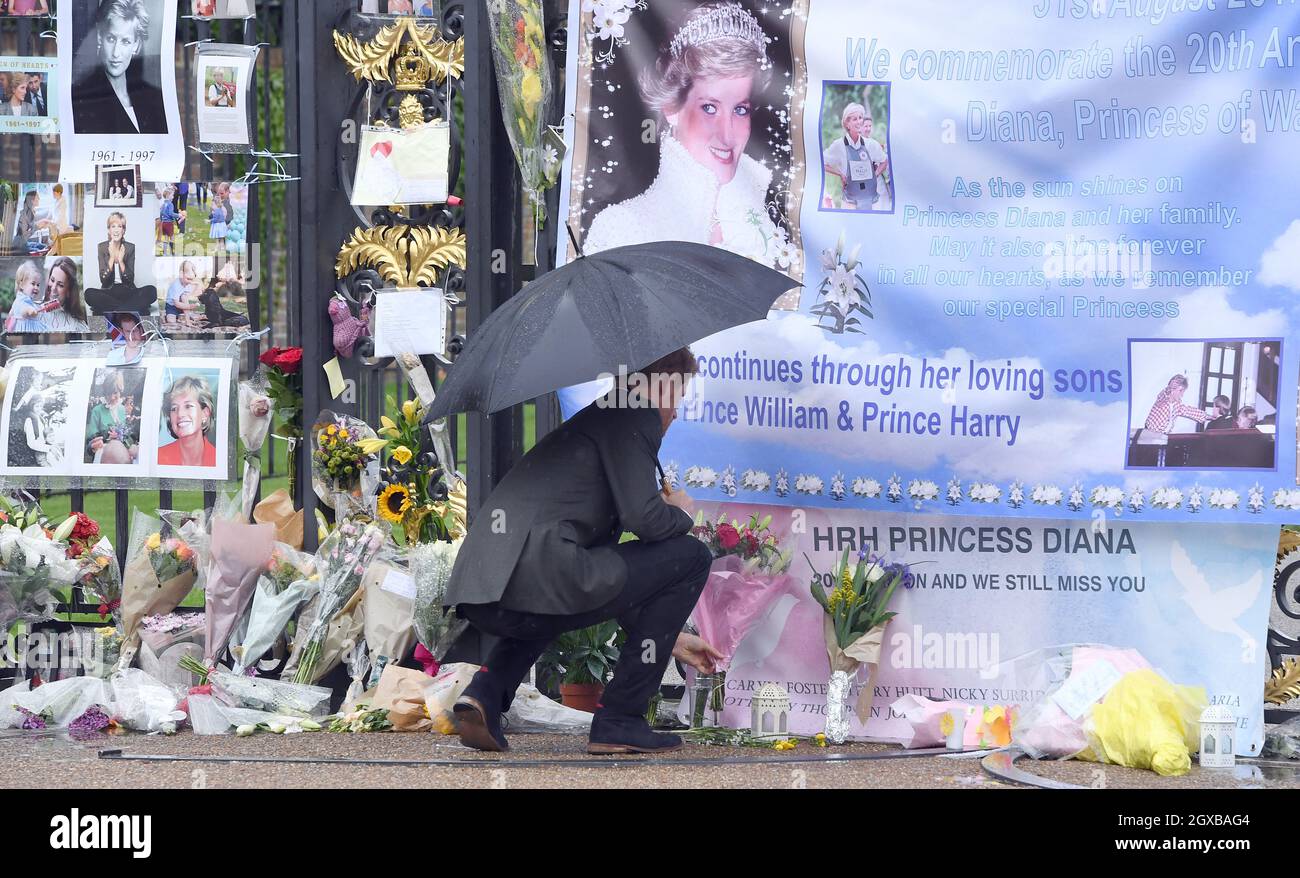 Prince Harry puts down a bouquet of flowers as he looks at tributes(02)