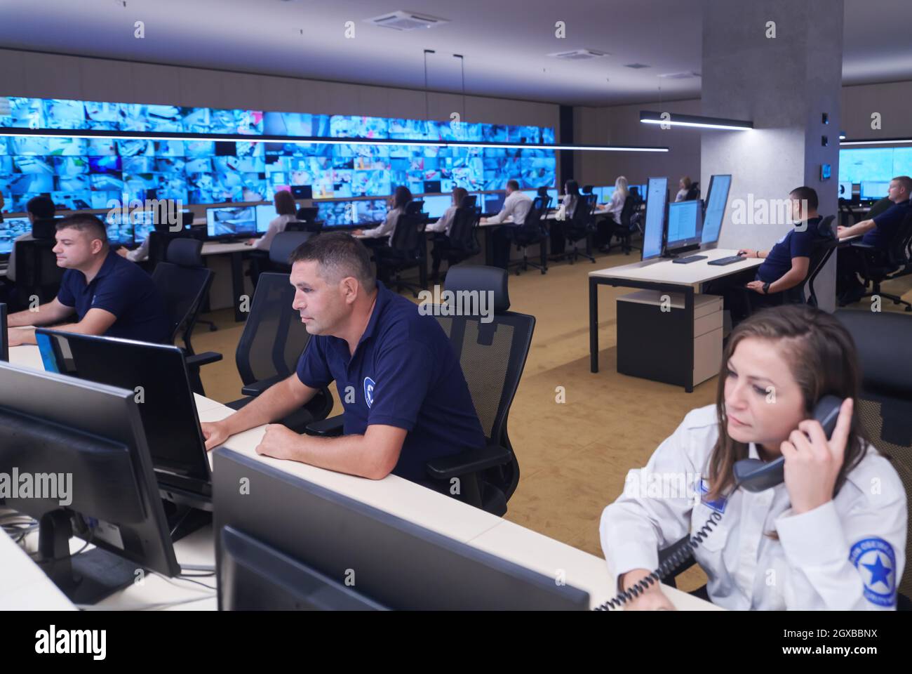 Group of Security data center operators working in a CCTV monitoring ...