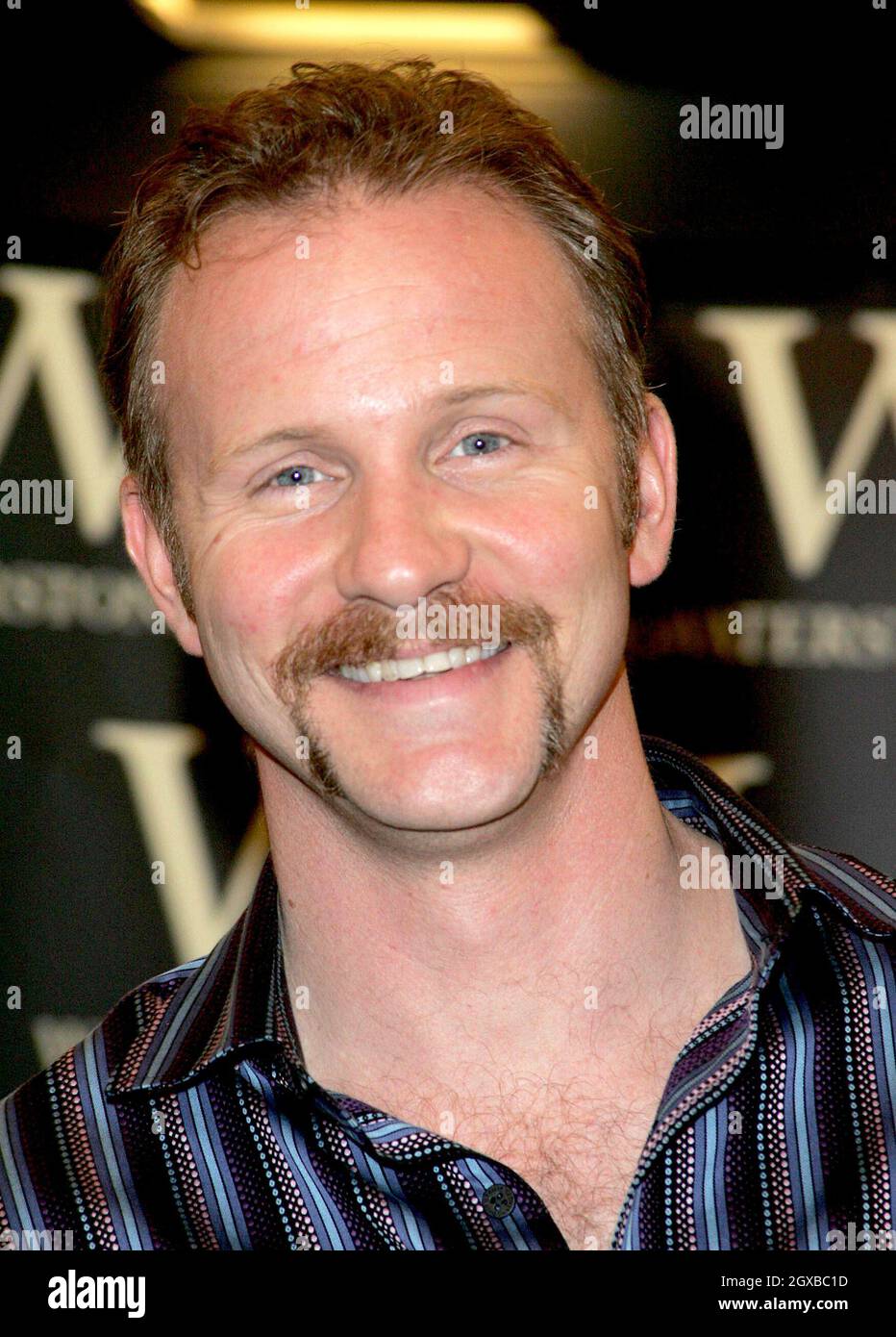 Morgan Spurlock pictured signing copies of his book Don't Eat This Book ...