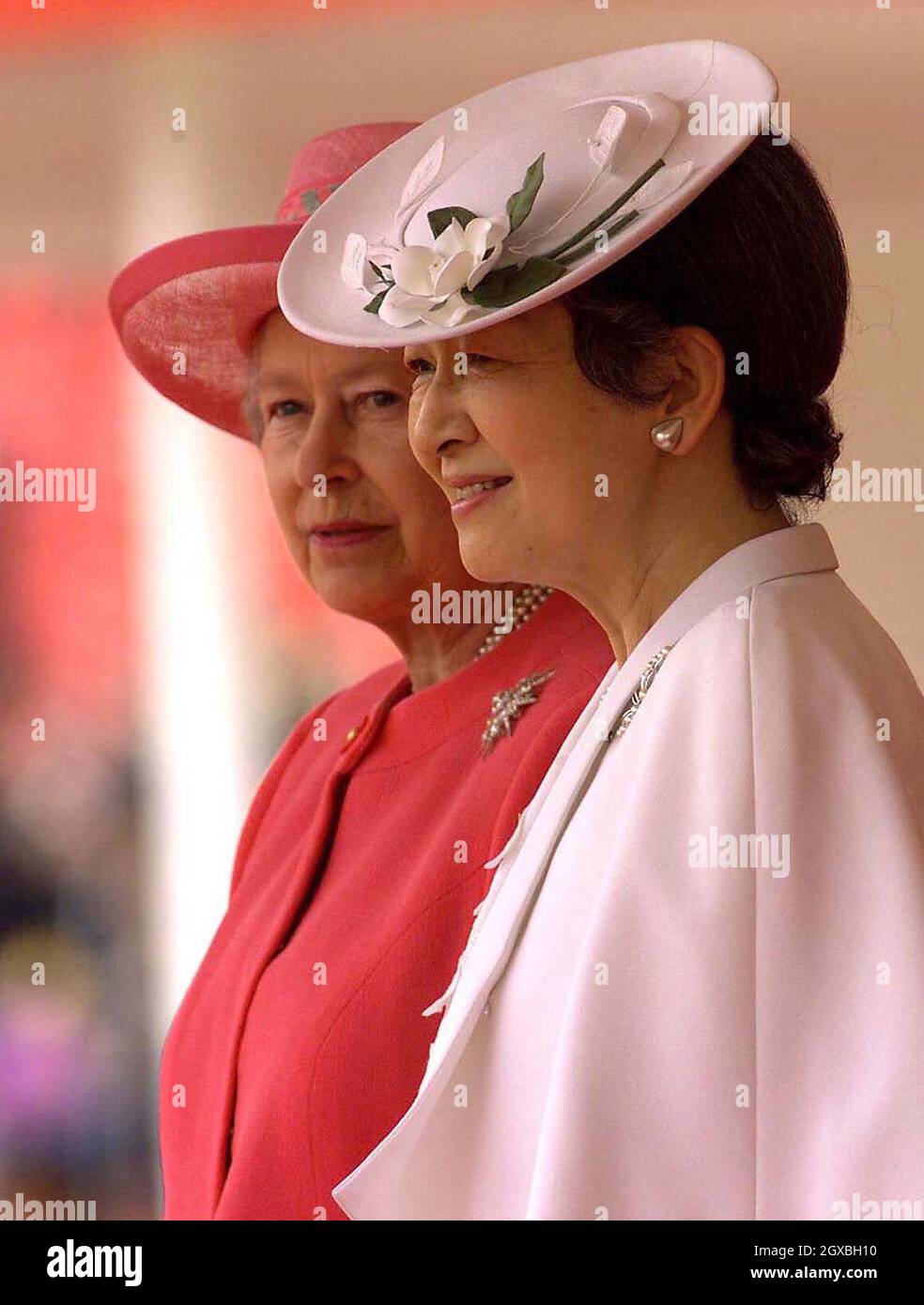 The Queen (left) and Japanese Empress Michiko stand together as their respective husbands inspect a guard of honour, at the start of the Emperor's state visit to Britain.  The Emperor faced a protest from hundreds of former Japanese prisoners of War who turned their back on the ceremonial procession as it passed by on its way to Buckingham Palace.  Â©Anwar Hussein/allactiondigial.com  Stock Photo