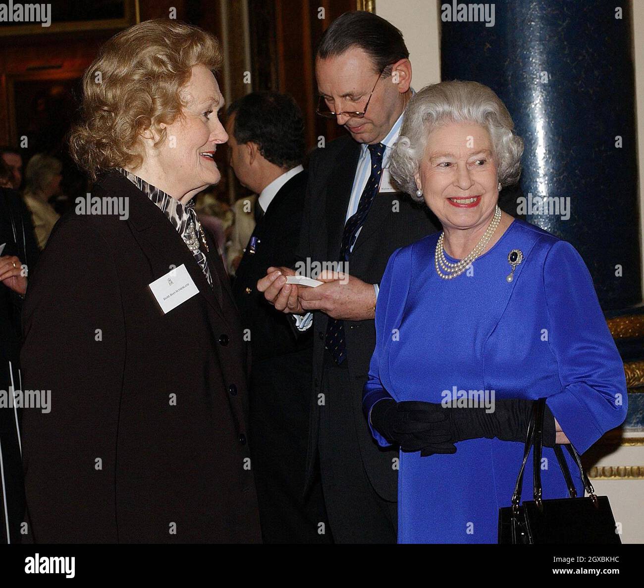 Britain's Queen Elizabeth II talks with opera singer Dame Joan Sutherland at the Reception and Lunch for Women Achievers held  at Buckingham Palace in London .  Stock Photo