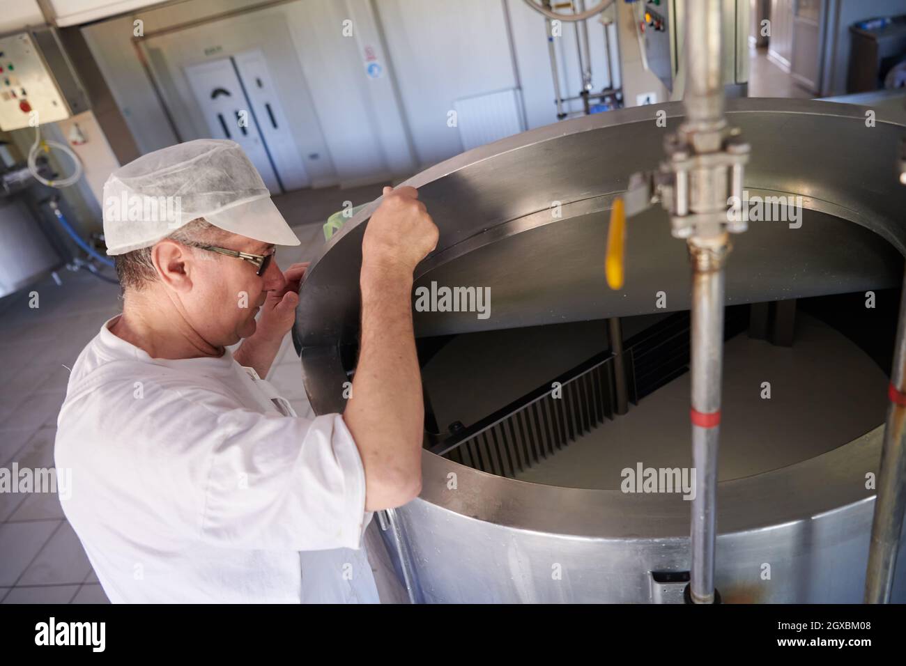 Cheese production male cheesemaker employee working in factory Stock ...