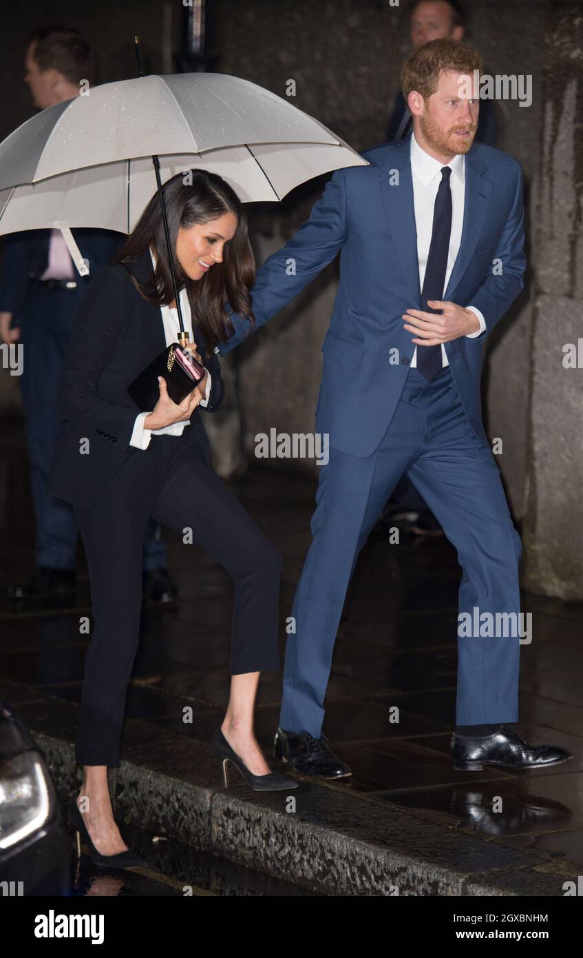 Prince Harry and Meghan Markle, attending their first official engagement together, arrive at the Endeavour Fund Awards at Goldsmiths' Hall in London on February 01, 2018.  Ms. Markle wore a dark Alexander McQueen trouser suit and white shirt for the occasion. Stock Photo