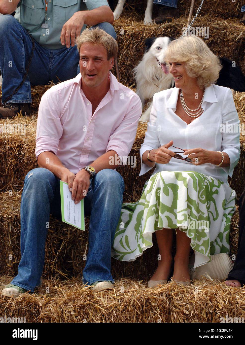 Camilla, Duchess of Cornwall sits on hay bales with Ben Fogle, presenter of the BBC's 'One Man and his Dog'. Stock Photo