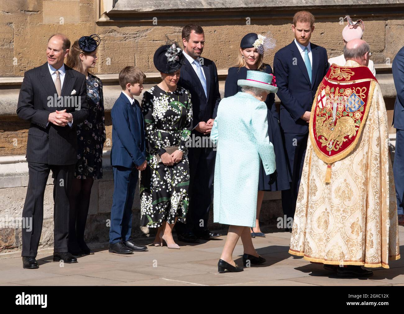 Queen Elizabeth ll is greeted by family members (l to r)  Prince Edward, Duke of Wessex, Lady Louise Windsor,James, Viscount Severn, Sophie, Countess of Wessex, Peter Phillips, Autumn Phillips and Prince Harry, Duke of Sussex as she attends the Easter Day Service at St.George's Chapel in Windsor  Stock Photo