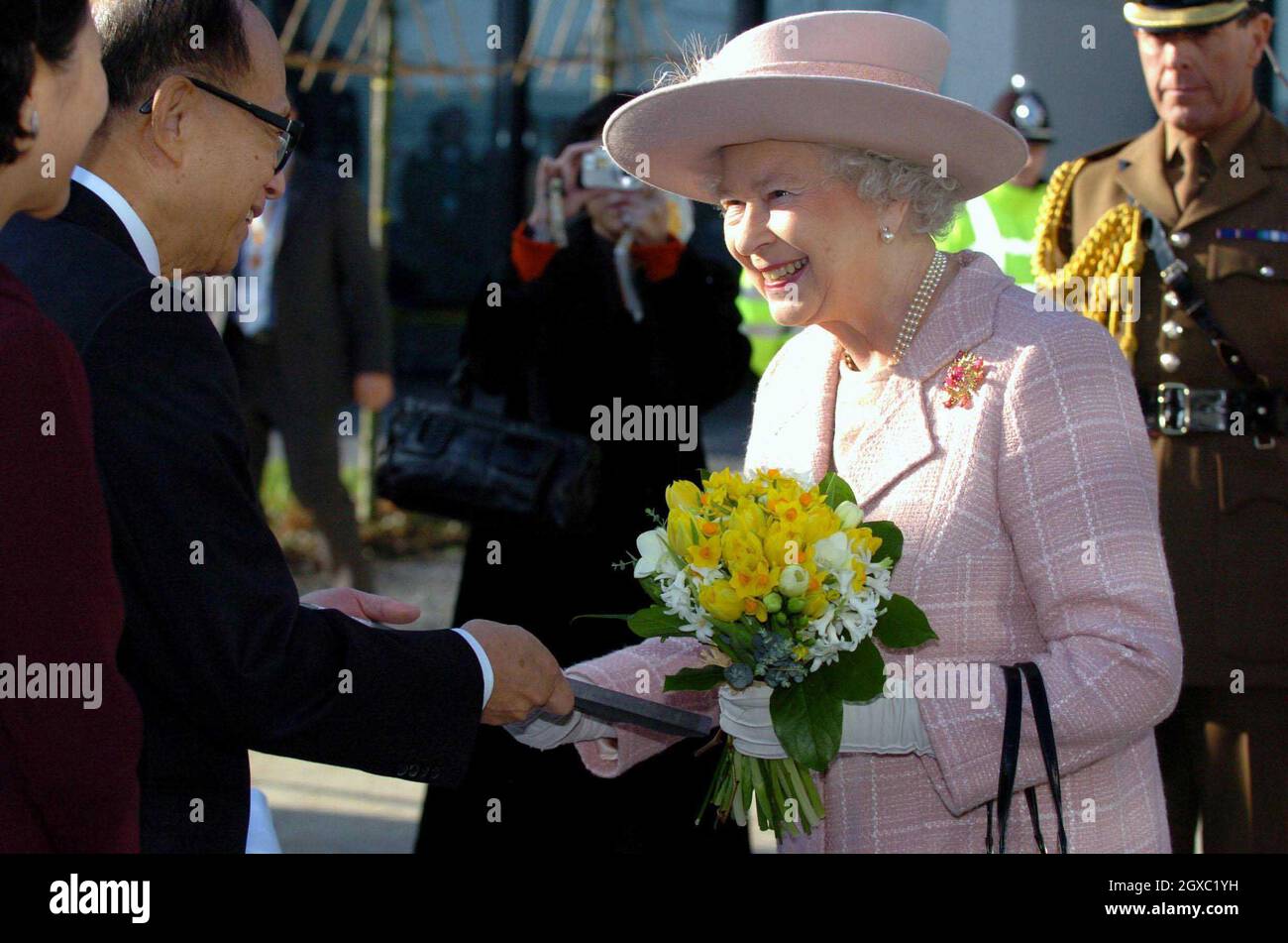 Queen Elizabeth II receives a gift from Li Ka Shing as she tours the newly opened Cancer Research UK Cambridge Research Institute at Cambridge University on February 2, 2007. The centre will bring together more than 300 scientists in the fight against the disease. Stock Photo