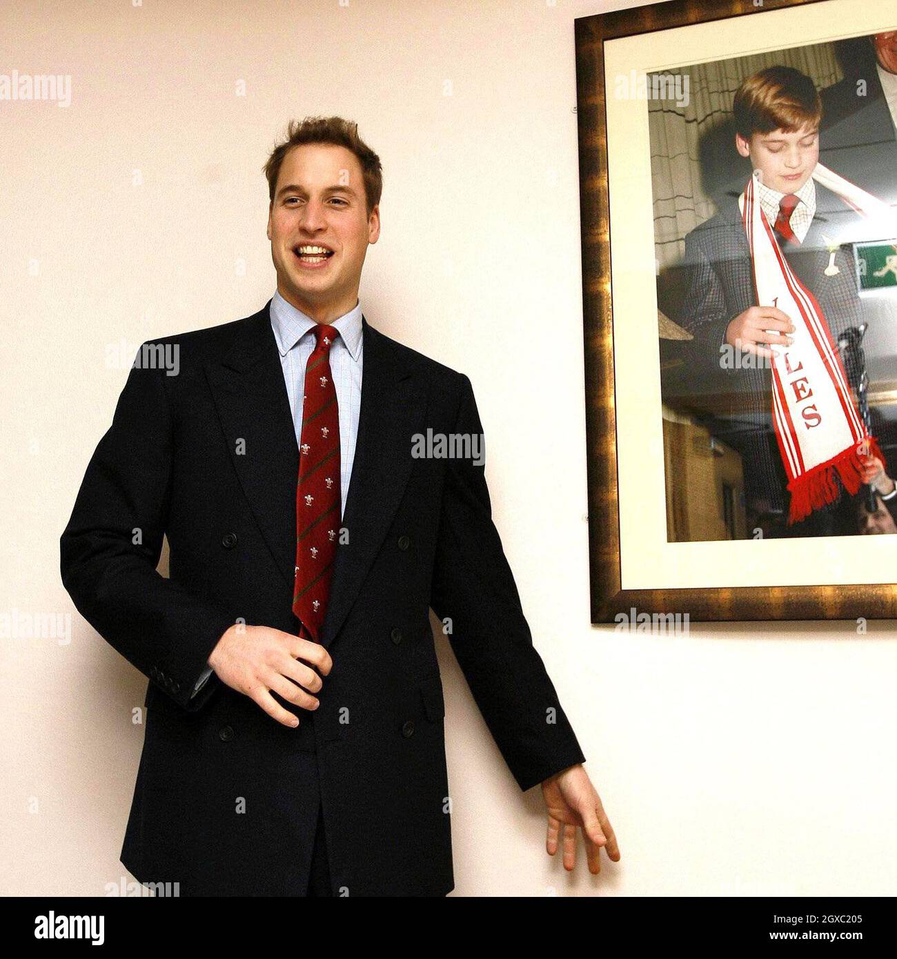 Prince William stands beside a picture of himself as a boy at the Millennium Stadium, Cardiff on February 4, 2007. Prince William officially took up his role as Vice Royal Patron of the Welsh Rugby Union. The prince was at the Millennium Stadium in Cardiff to see Wales play Ireland in their opening game of the Six Nations tournament. Anwar Hussein/EMPICS Entertainment Stock Photo