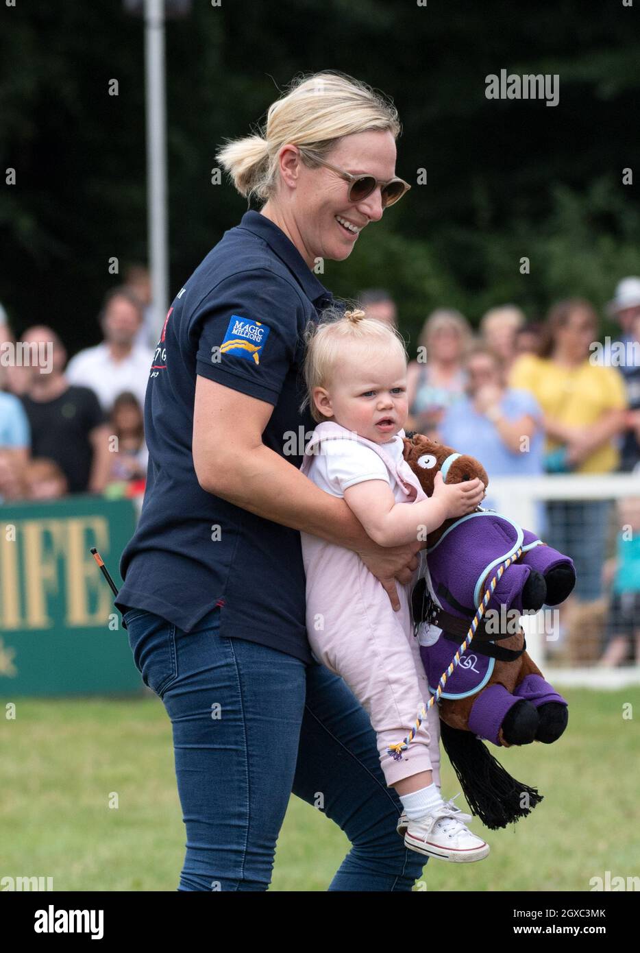 Zara Tindall carries daughter Lena Tindall as Savannah Phillips looks on  during the Festival of British Eventing at Gatcombe Park Stock Photo - Alamy