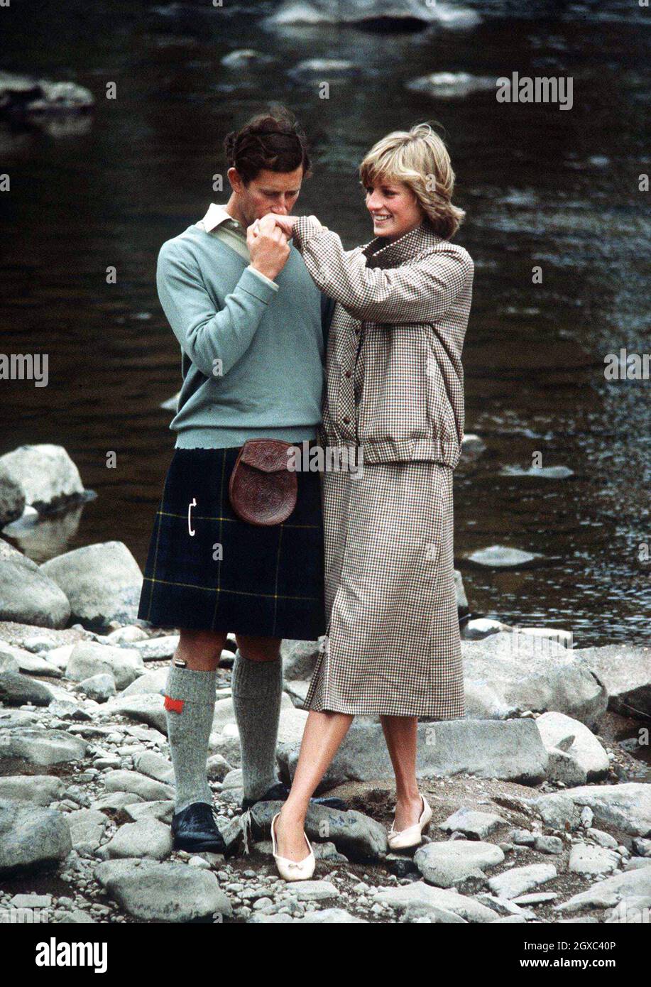Prince Charles, Prince of Wales kisses Diana, Princess of Wales on the hand as they pose by the River Dee for the press on their honeymoon at Balmoral in Scotland in August 1981. Stock Photo