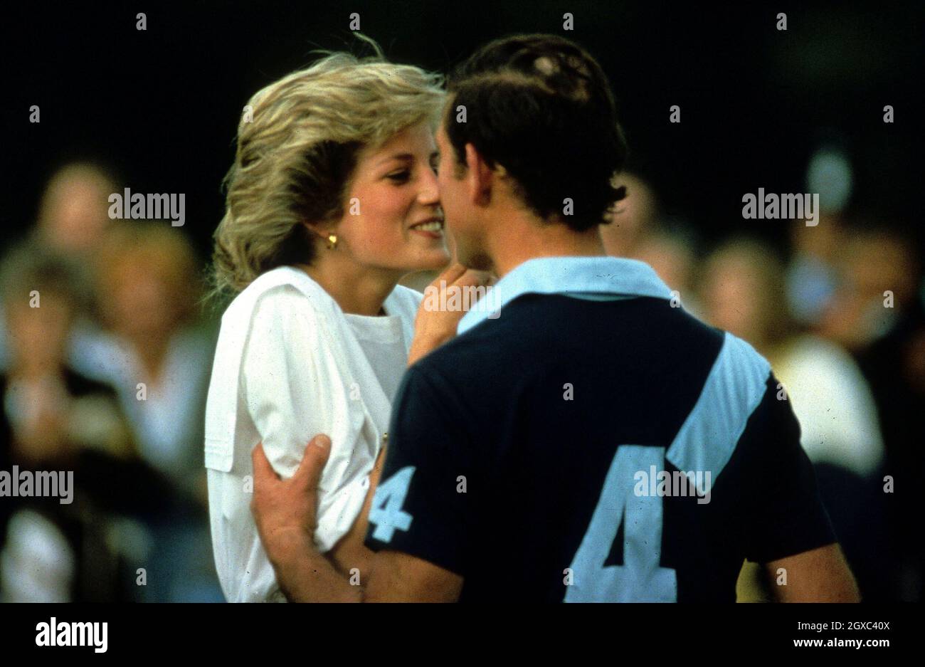 Diana, Princess of Wales and Prince Charles, Prince of Wales kiss during a polo match at Cirencester Polo Club in July, 1985. Stock Photo