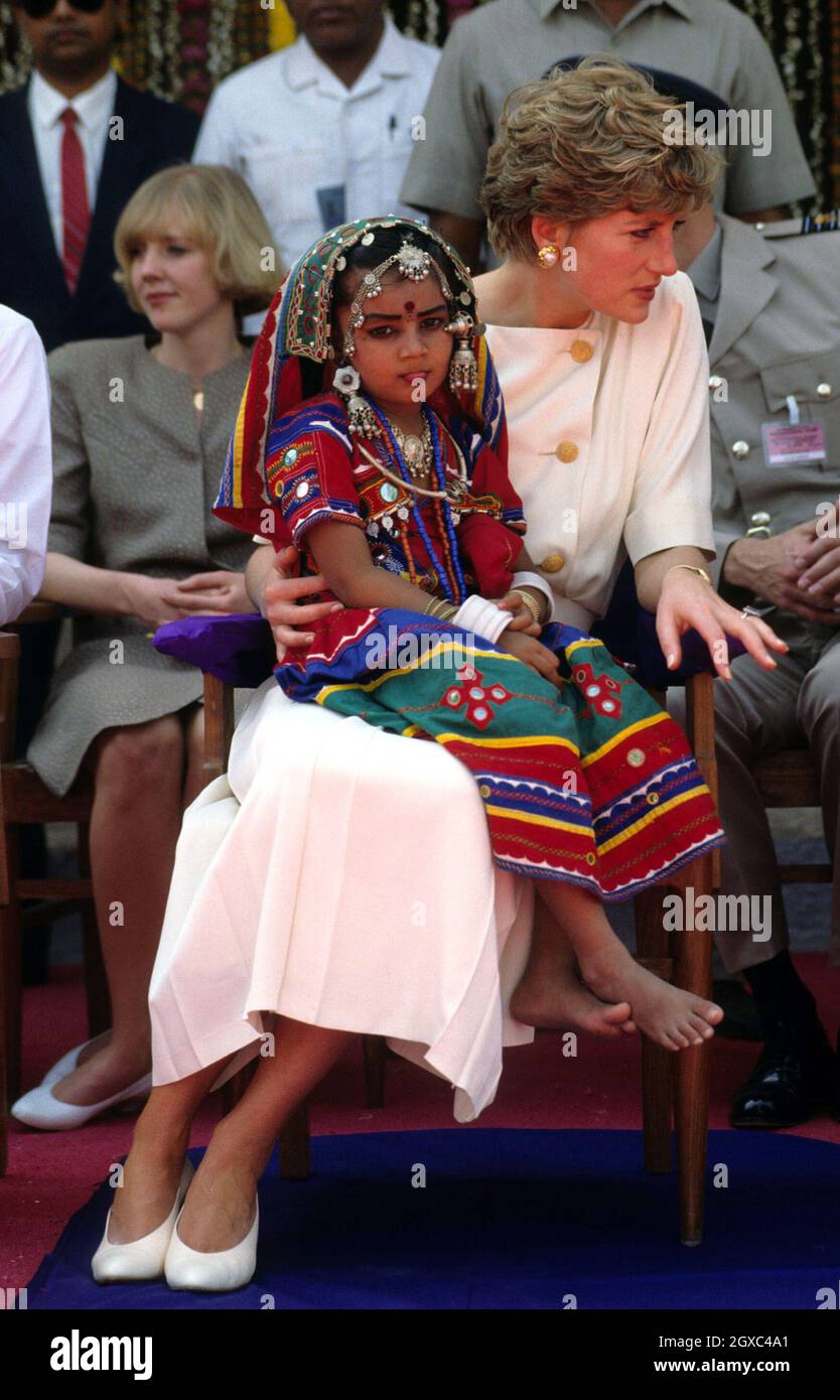 Diana, Princess of Wales holds a young Indian dancer on her knees when she visits Hyderabad, India in February, 1992. Stock Photo