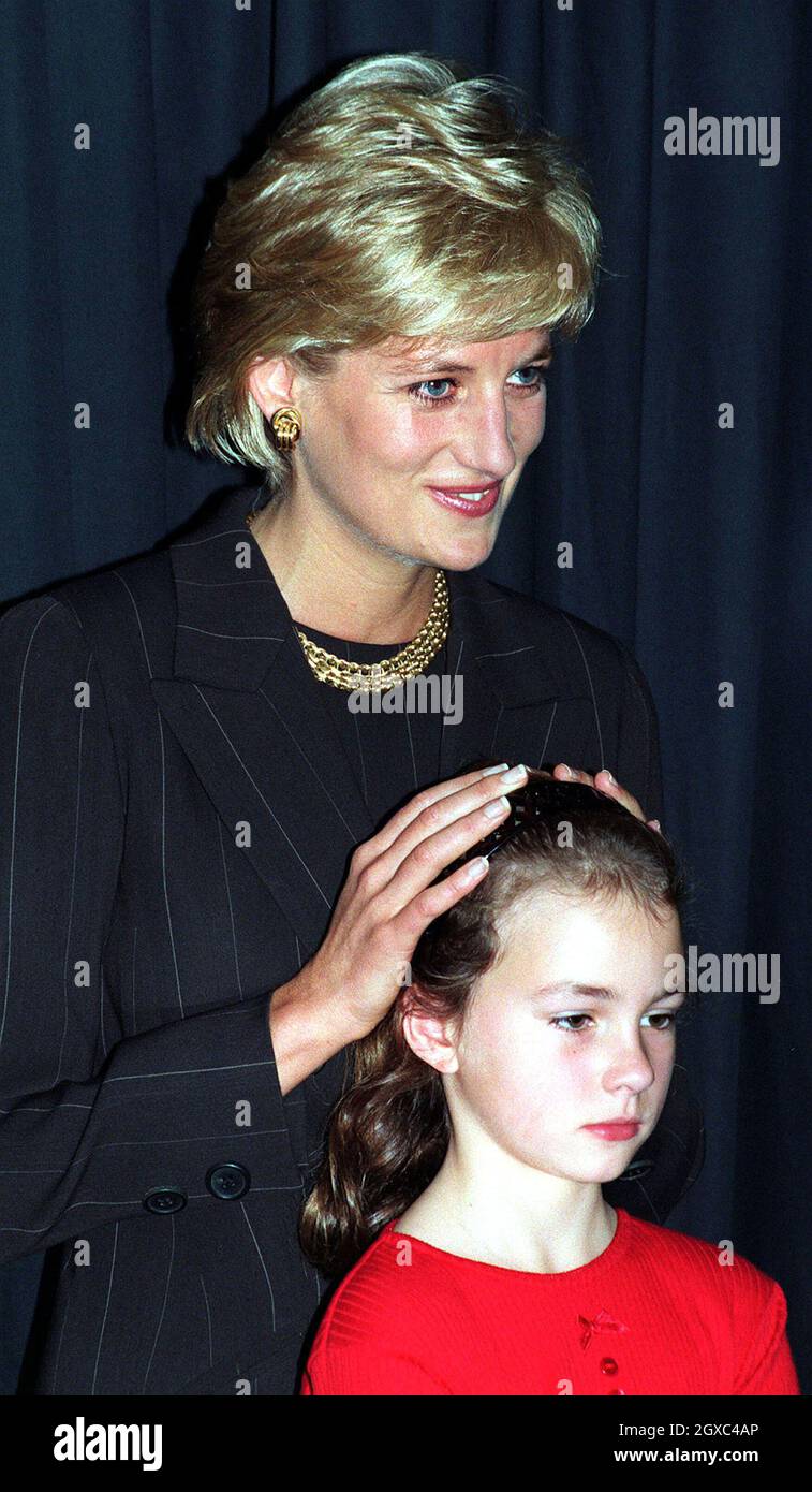 Diana, Princess of Wales lays her hands on a young child whose life was ...
