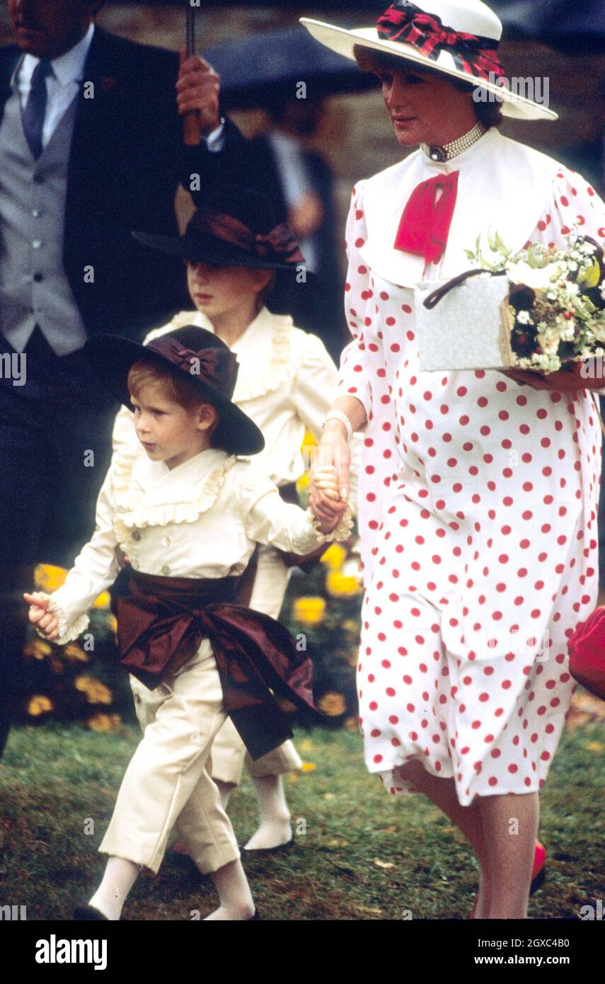 Prince Harry enjoys his role as a pageboy as he arrives with Lady Sarah McCorquodale (Princess Diana's sister), at the wedding of his uncle, Viscount Althorp, to Victoria Lockwood on September 17, 1989 in Althorp, England. Stock Photo