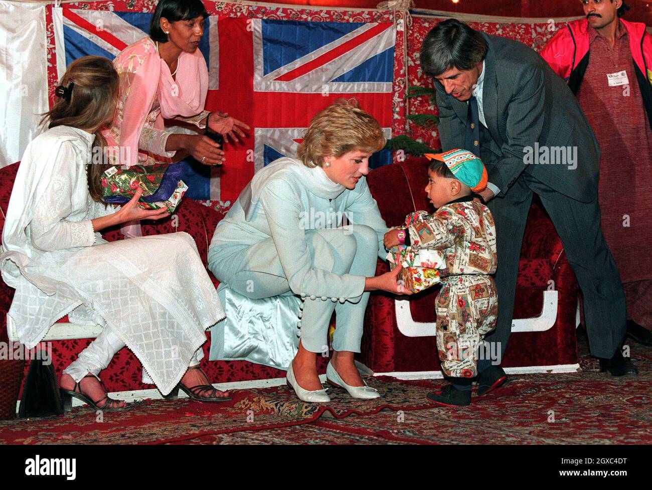 Diana, Princess of Wales and Jemima Khan give presents to sick children during a visit to Imran Khan's cancer hospital in Lahore, Pakistan during April 1996. Stock Photo